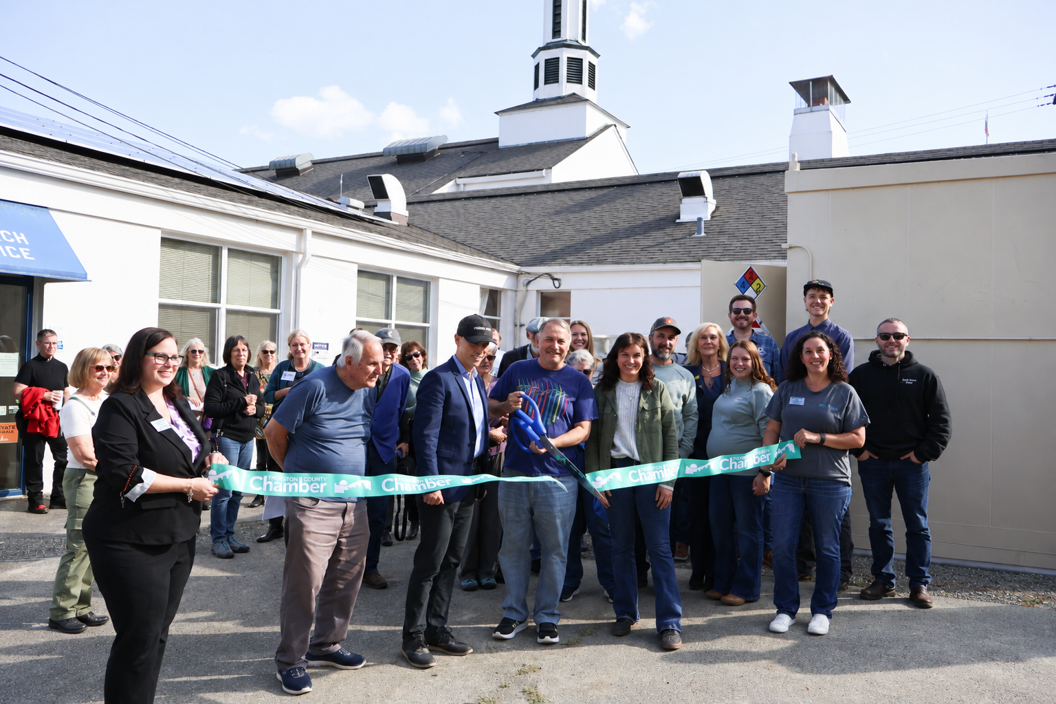 Image of the ribbon cutting with project partners in attendance.