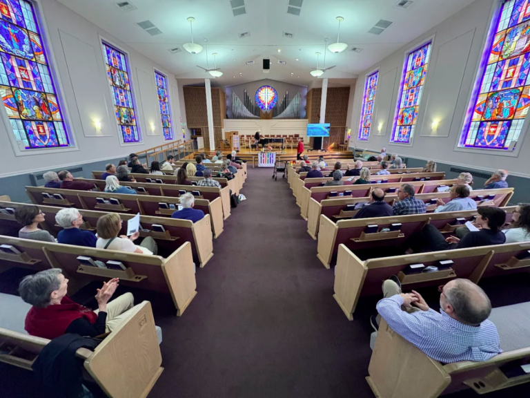 Image of the inside of the church in session.