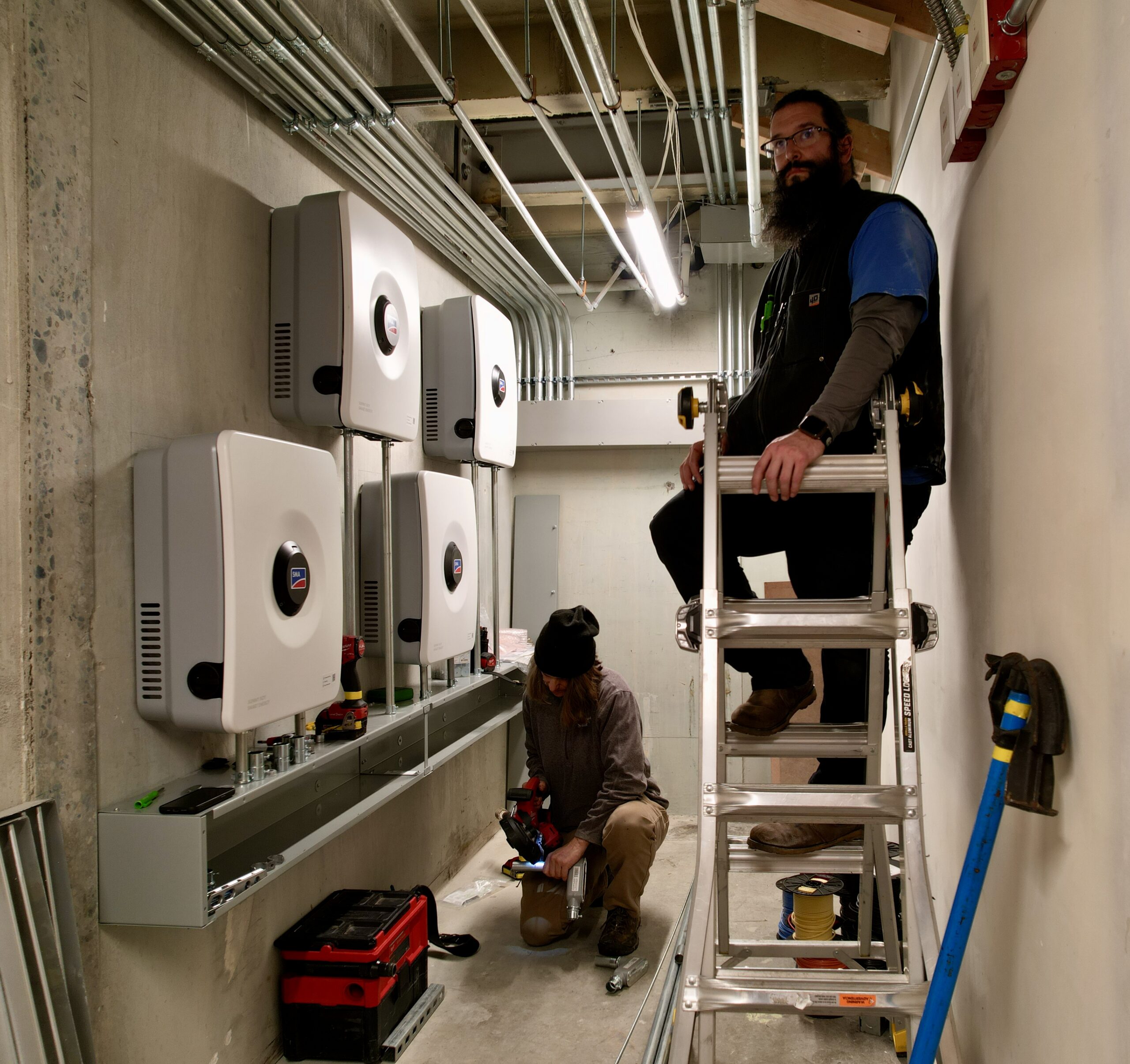 Image of South Sound Solar crew installing the four-battery storage system.