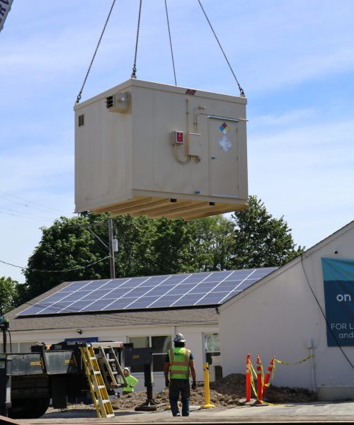 Image of installation equipment being lifted by crane.